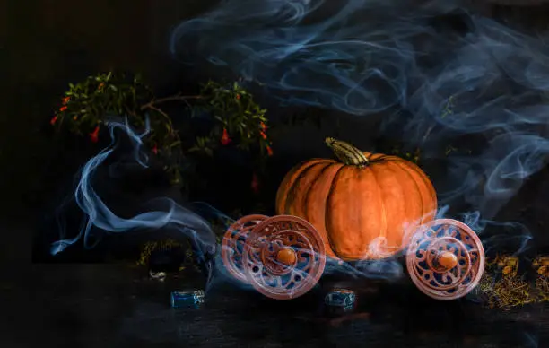 Magic pumpkin carriage and mist on dark baskground.
