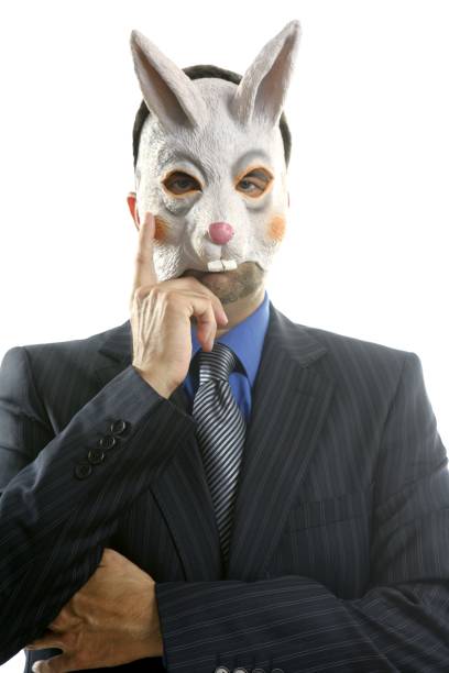 Businessman with funny rabbit mask over white studio background