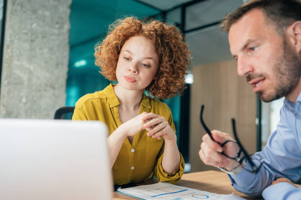 istock Two business people working together in office 1342498283