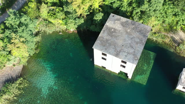 An aerial view of abandon buildings partially submerged in the waters of an old quarry in Verplanck New York.