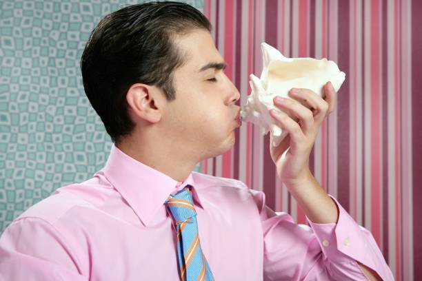 Businessman with sea shell, vacations metaphor in wallpaper office