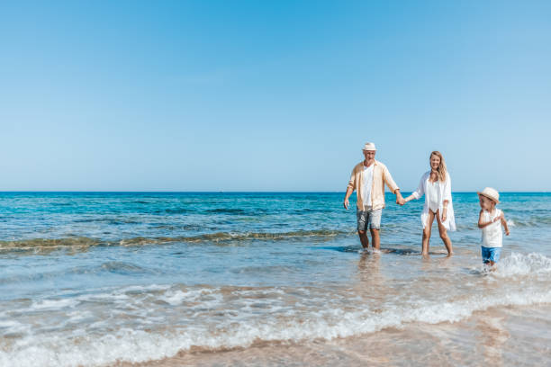 istock Family walking at beach 1342500513