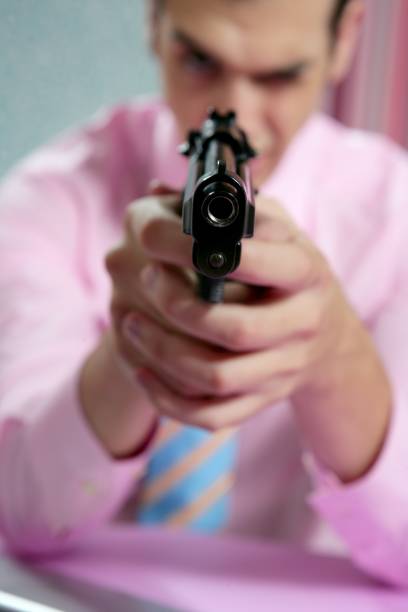 istock Businessman point his handgun to camera 1342501672