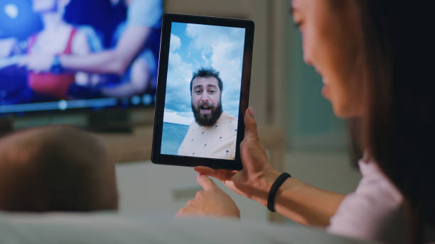 istock Mother and child making video call to father 1342501996