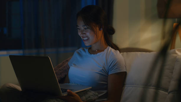 istock Asian woman making video call at night 1342503375
