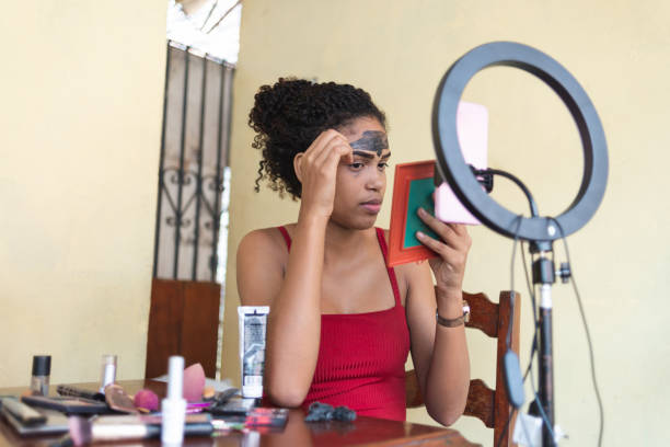 istock Black woman giving a live video tutorial about peeling off mask for face skin care 1342504278