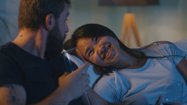 istock Multiracial couple discussing movie on couch 1342505585