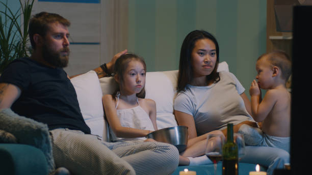 istock Parents with kids watching TV 1342505946