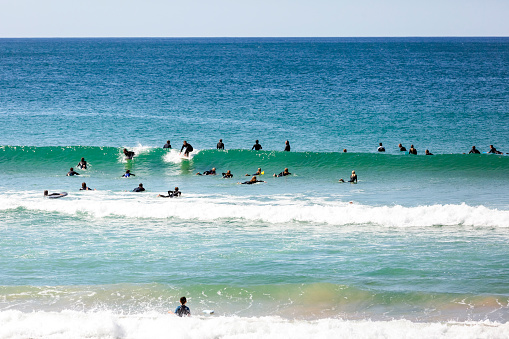 Cronulla, Australia - September 19, 2021: Wanda beach, group of surfers enjoying the waves