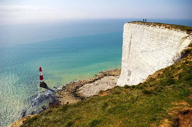 Lighthouse below the coastal cliffs called Seven Sisters in UK