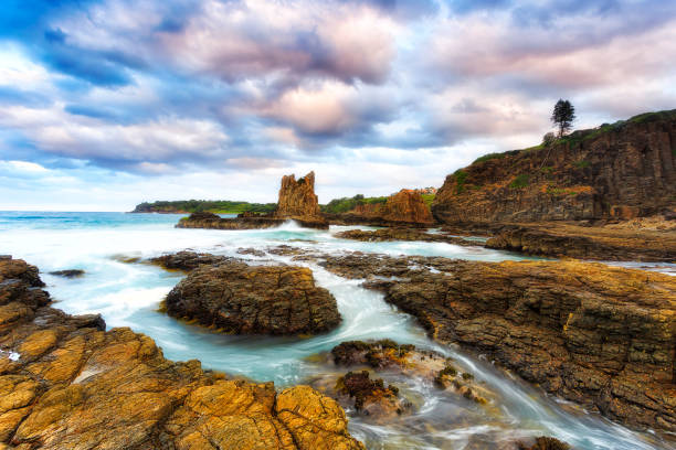 Cathedral rock off Bombo beach near basalt quarry in coastal Kiama town of Australia, Pacific.