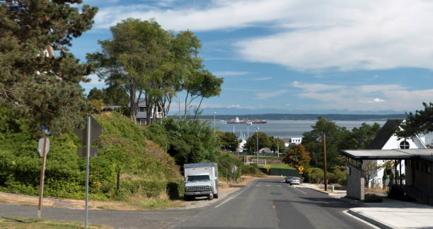 Looking in Port Townsend down Jefferson street at cargo ship  near Hudson point stock photo