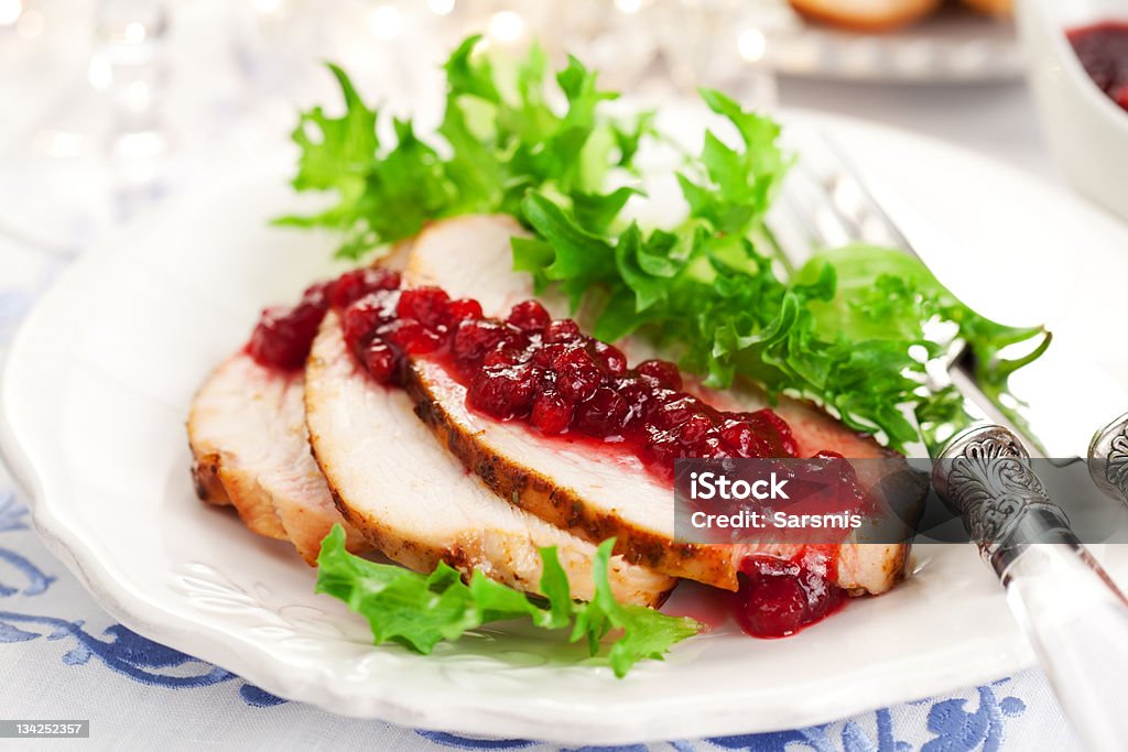 Sliced up turkey breast with cranberry sauce Turkey breast with cranberry sauce for Christmas dinner Cranberry Stock Photo