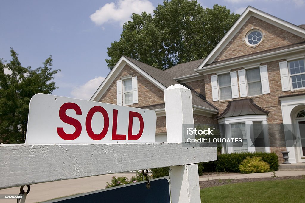 House sold sign Sold house sign in Midwest suburban setting. Focus on sign. Selling Stock Photo