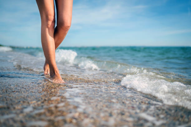 istock Young woman walks at beach during sunset 1342529661