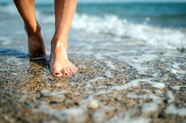 istock Young woman walks at beach during sunset 1342529664
