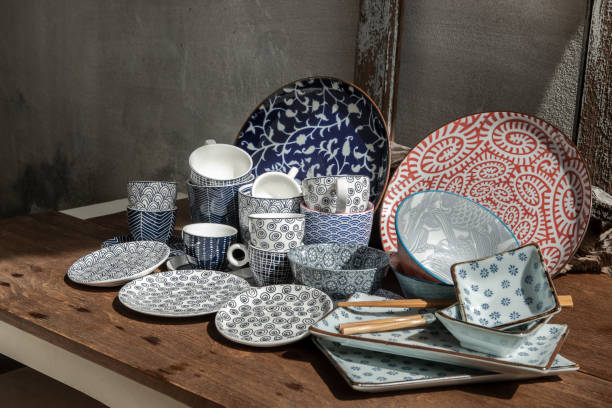 istock Different Ceramic Plates, Bowl and cup on wooden table. 1342530560