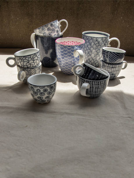 istock Set of Blue ceramics cups on calico fabric cloth. Ceramic tableware. 1342530602