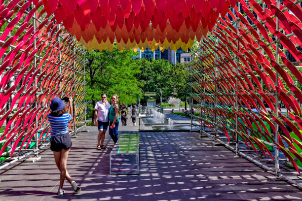 des touristes prennent des photos au milieu de l’installation d’art public « à l’ombre des cosmos » au centre-ville de montréal en été - être à lombre photos et images de collection