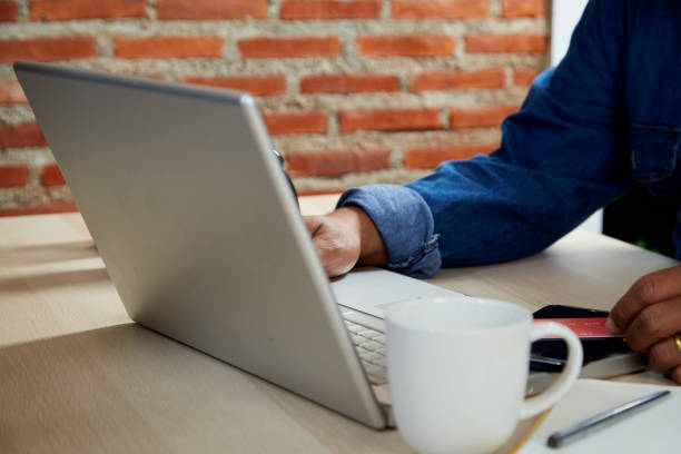 istock Close up business man working by using a laptop computer on wooden table laptop 1342555638