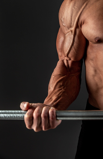 Detail of a bodybuilder arm during power lift