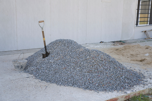 Pile of gravel at wood frame house construction