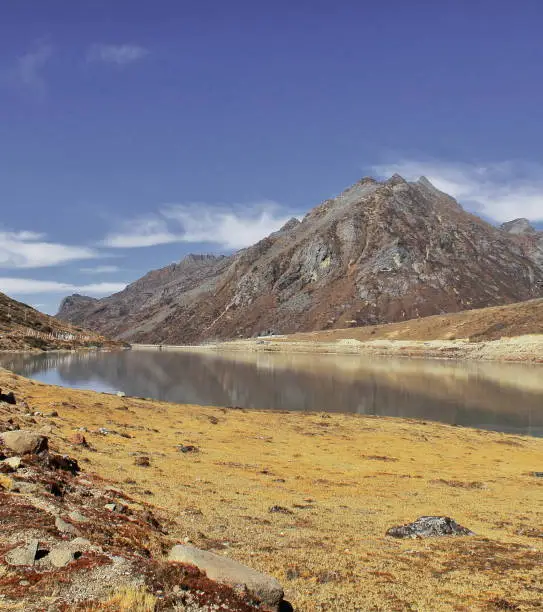 Beautiful Sela lake, alpine valley and rocky mountain peak with blue sky at Sela pass, Tawang in Arunachal Pradesh in India