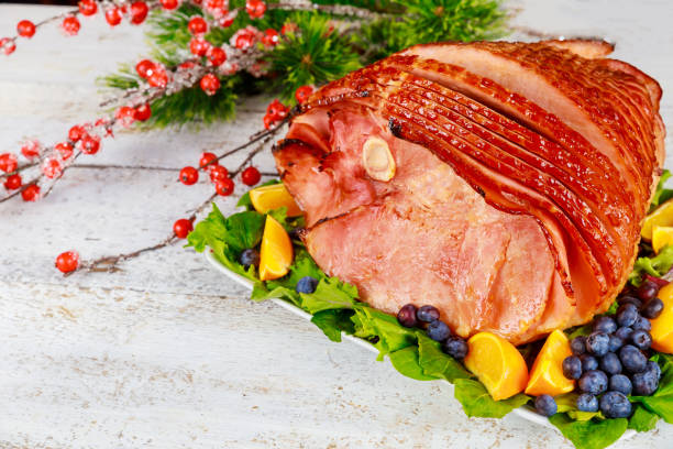 istock Spiral sliced hickory smoked ham with fresh orange and blueberries. 1342575206