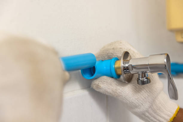 istock Worker installing floating pipeline on the wall in the old bathroom 1342576903