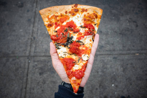 istock Handheld New York Style Margherita Pizza Slice 1342585147