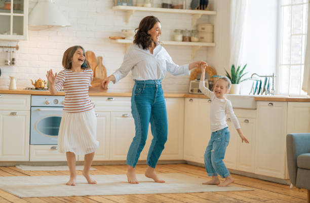 istock Mom and her daughters are dancing. 1342587203