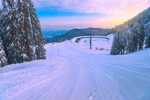 Photo of Ski slopes with cable cars at sunrise, Poiana Brasov, Romania