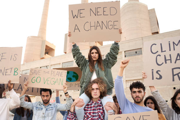 istock People with banners protest as part of a climate change march. 1342591091