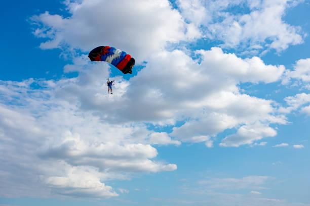 parachute sur le ciel bleu - action adventure aerospace industry air vehicle photos et images de collection