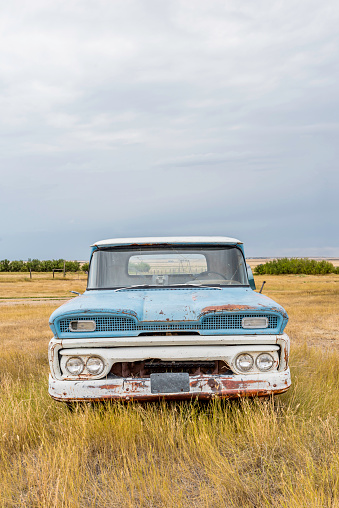 Abandoned vintage blue and white pick up truck on the Saskatchewan prairies