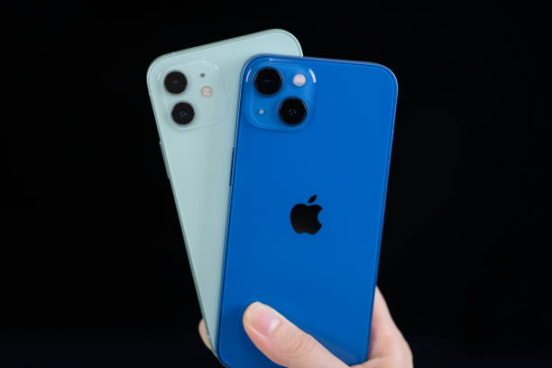 iPhone 13 in blue and iPhone 12 in green iPhone 13 in blue and iPhone 12 in green. Manhattan, New York, USA September 25, 2021. iphone 13 photos stock pictures, royalty-free photos & images