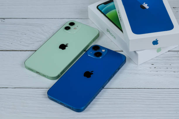 iPhone 13 in blue and iPhone 12 in green iPhone 13 in blue and iPhone 12 in green. Manhattan, New York, USA September 25, 2021. iphone 13 photos stock pictures, royalty-free photos & images