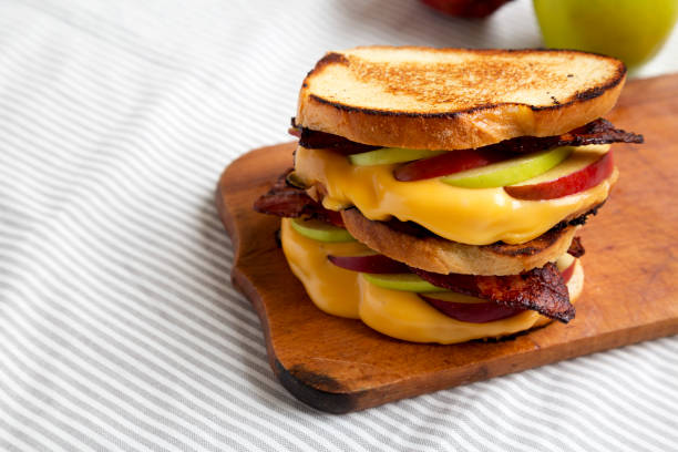 istock Homemade Bacon Apple Grilled Cheese on a rustic wooden board, low angle view. Copy space. 1342601203