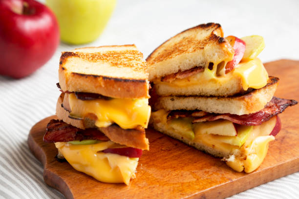 istock Homemade Bacon Apple Grilled Cheese on a rustic wooden board, side view. Close-up. 1342601237