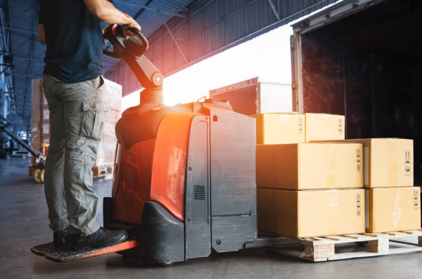 Forklift Driver Loading Package Boxes into Cargo Container at Dock Warehouse. Delivery Service. Shipping Warehouse Logistics. Cargo Shipment. Freight Truck Transportation. Forklift Driver Loading Package Boxes into Cargo Container at Dock Warehouse. Delivery Service. Shipping Warehouse Logistics. Cargo Shipment. Freight Truck Transportation. loading bay stock pictures, royalty-free photos & images