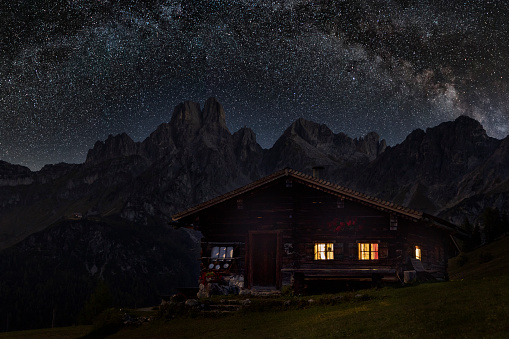 Lightened mountain hut in the alps with milky way - Sulzenalm