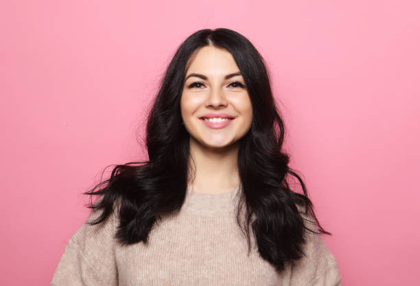 istock Caucasian female with positive expression poses against pink background 1342607946