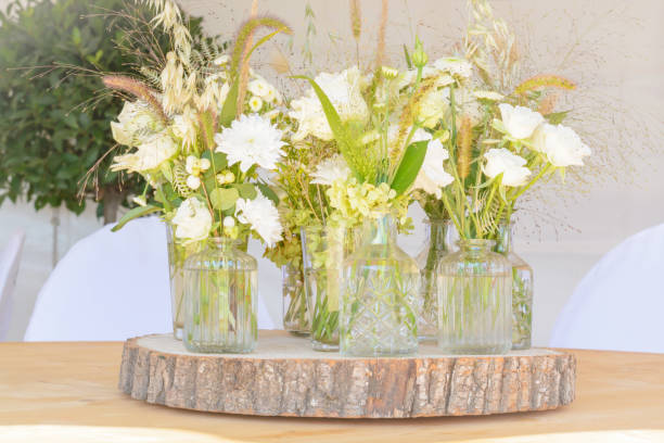 istock Several small bouquets in glass vases with light flowers 1342610135