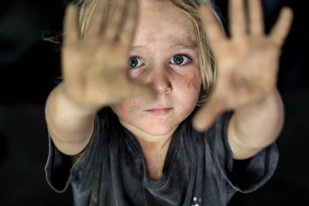 Sad boy looking dirty A boy looks dirty holding out his hands to the camera with a very sad look in his eyes poor hygiene stock pictures, royalty-free photos & images