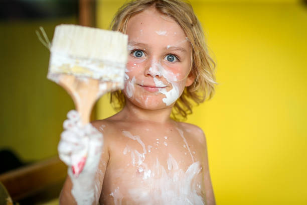 istock Wide blue eyed boy and a paintbrush 1342615957