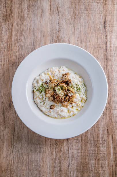 istock Mushroom risotto in a white bowl 1342622004