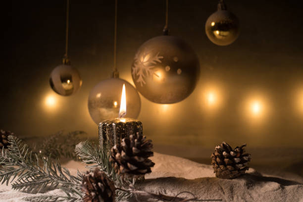 istock Creative artwork decoration. Christmas decoration with burning candles on a dark background. Christmas ornaments over dark golden background with lights. 1342623380
