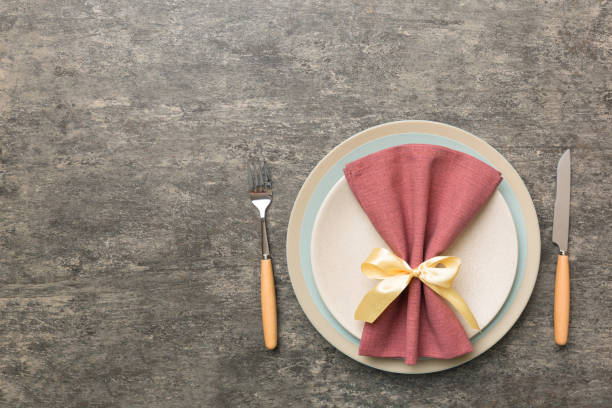 istock Christmas table place setting with christmas decor and plates, kine, fork and spoon. Christmas holiday background. Top view with copy space 1342623415