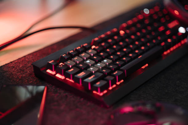 istock gamer work space concept, top view a gaming gear, mouse, keyboard, joystick, headset, mobile joystick, in ear headphone and mouse pad on black table background. 1342628775