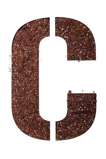 stencil letter C made above dirt on white surface